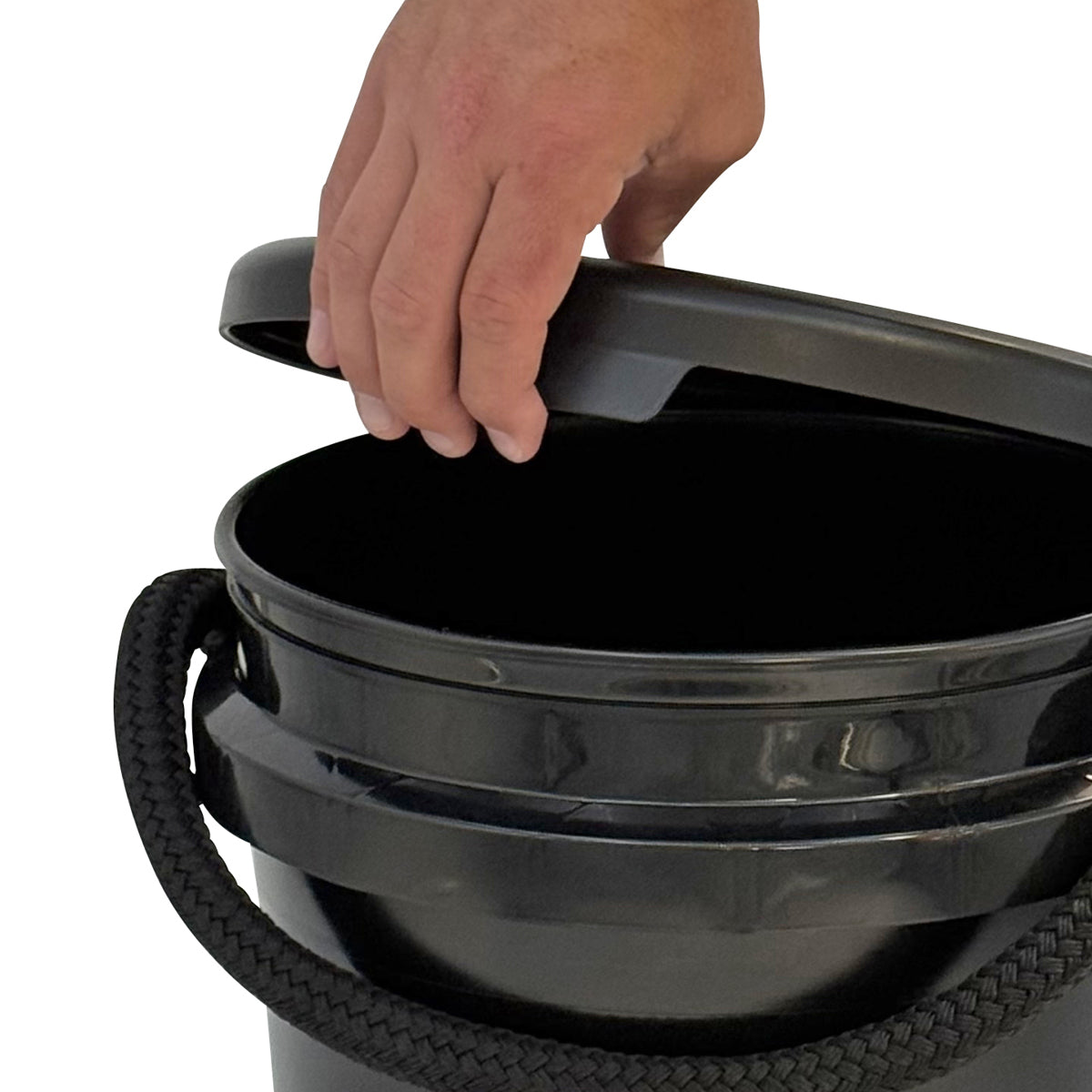 A hand lifts the Shurhold Industries, Inc. Bucket Lid off a black plastic bucket, highlighting its easy-snap fit and ergonomic release tab for convenient use.