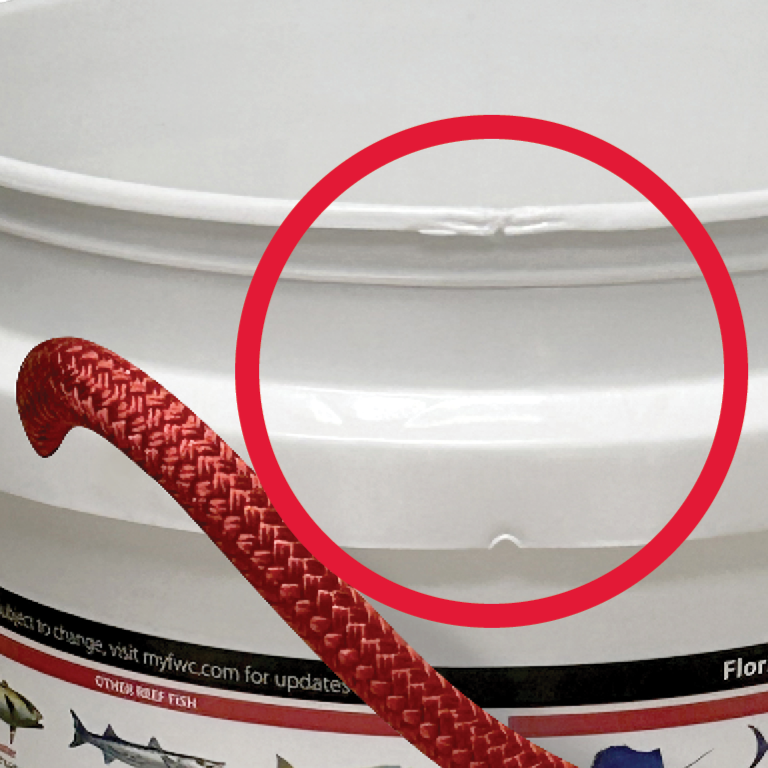 A close-up of the ONE SURPRISE BUCKET by Shurhold Industries, Inc. with a red rope handle. A red circle highlights a crack on the rim, emphasizing its great value even with minor imperfections.