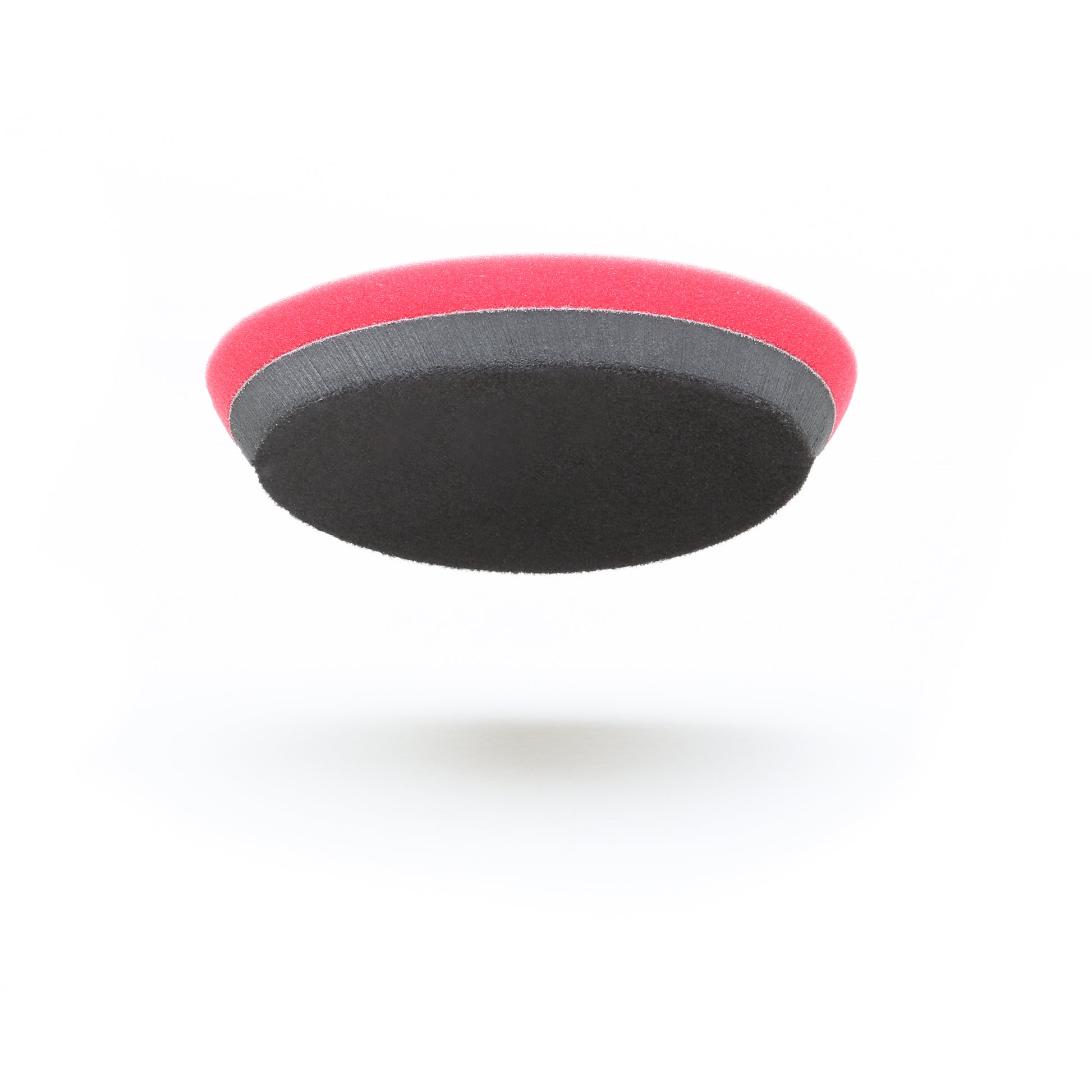 The Pro Polish Pad for DAP PRO by Shurhold Industries, Inc. is a round, multi-layered 7 foam pad in black, gray, and red—ideal for polishing and waxing with the Shurhold Dual Action Polisher PRO. Shown on a white background.