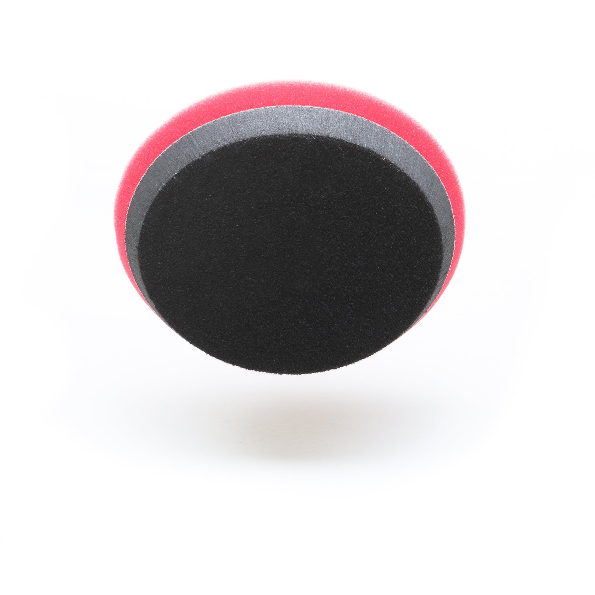 The Shurhold Industries, Inc. Pro Polish Pad for DAP PRO is a round, two-tone 7 foam pad with a black surface, gray stripe, and red edge—perfect for polishing and waxing with the Dual Action Polisher PRO. Shown on a white background.