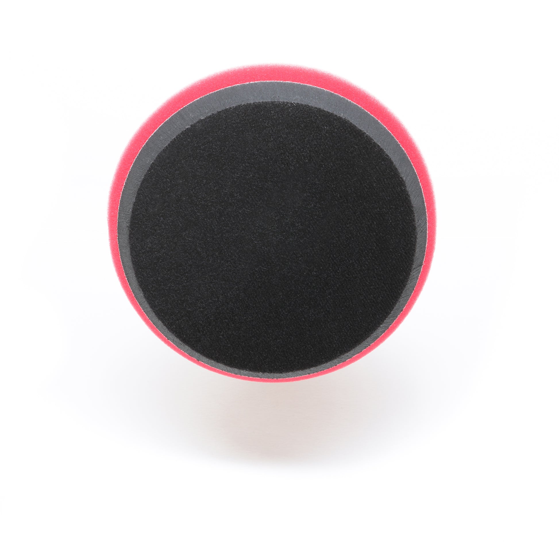 A round, black and red 7 Pro Polish Pad for DAP PRO by Shurhold Industries, Inc. is shown from above with a black center and red rim—ideal for efficient polishing and waxing with the Dual Action Polisher PRO.