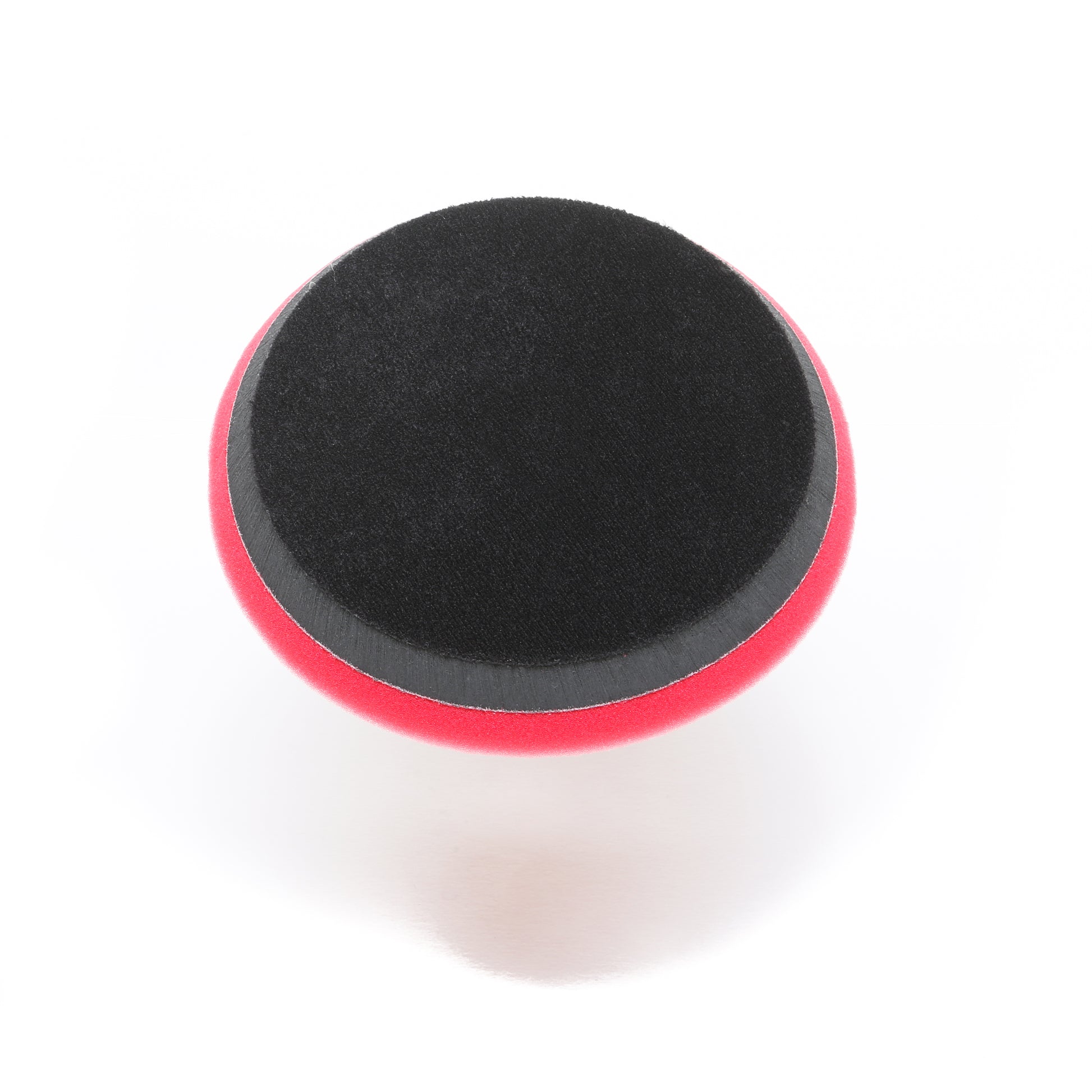 The Shurhold Pro Polish Pad for DAP PRO, a round 7 foam pad with black top and red side, is ideal for polishing and waxing with the Dual Action Polisher PRO. Product by Shurhold Industries, Inc.; shown on a white background.