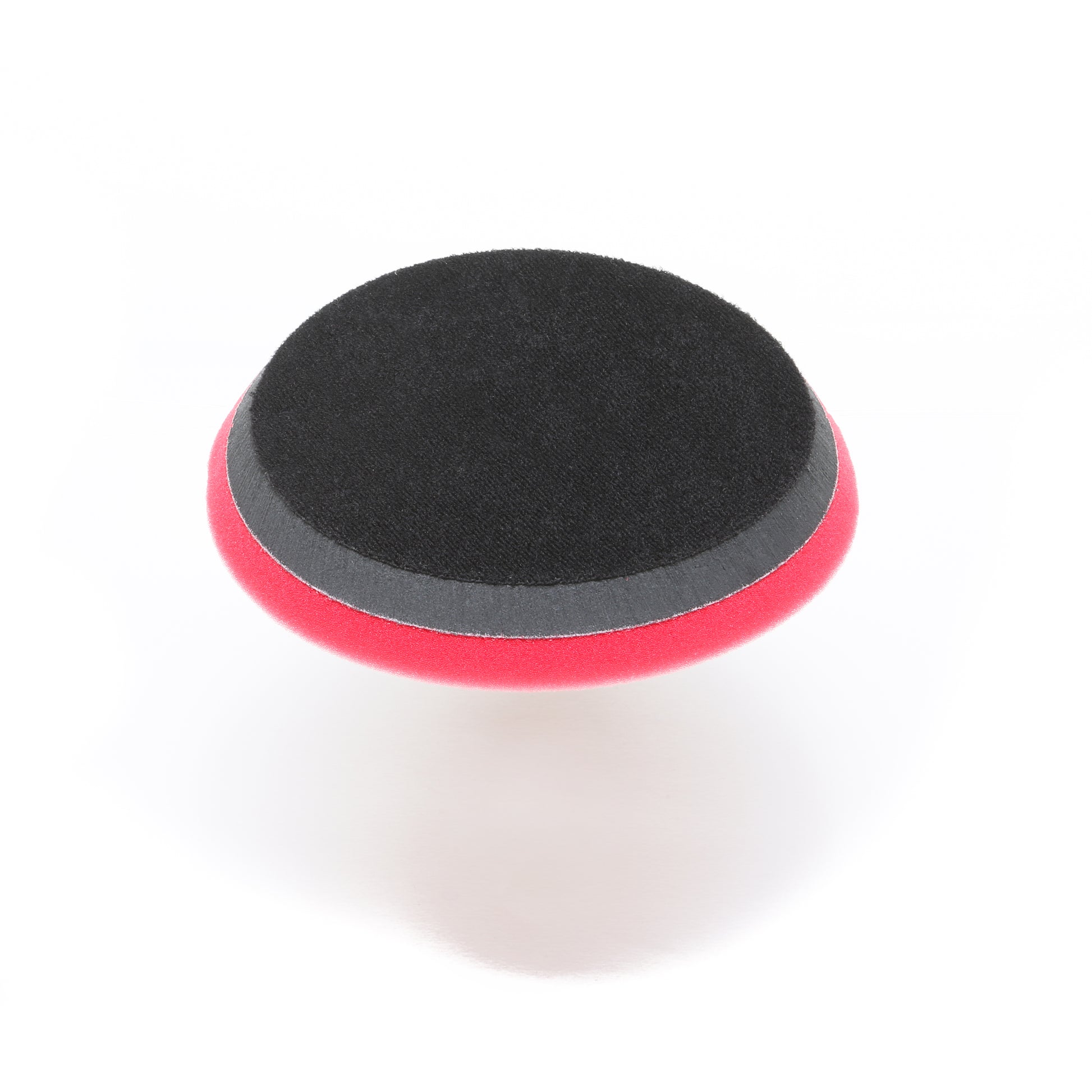 The Pro Polish Pad for DAP PRO by Shurhold Industries, Inc. is a round black and red 7 foam pad for polishing and waxing, shown on a white background and designed to fit the Shurhold Dual Action Polisher PRO.