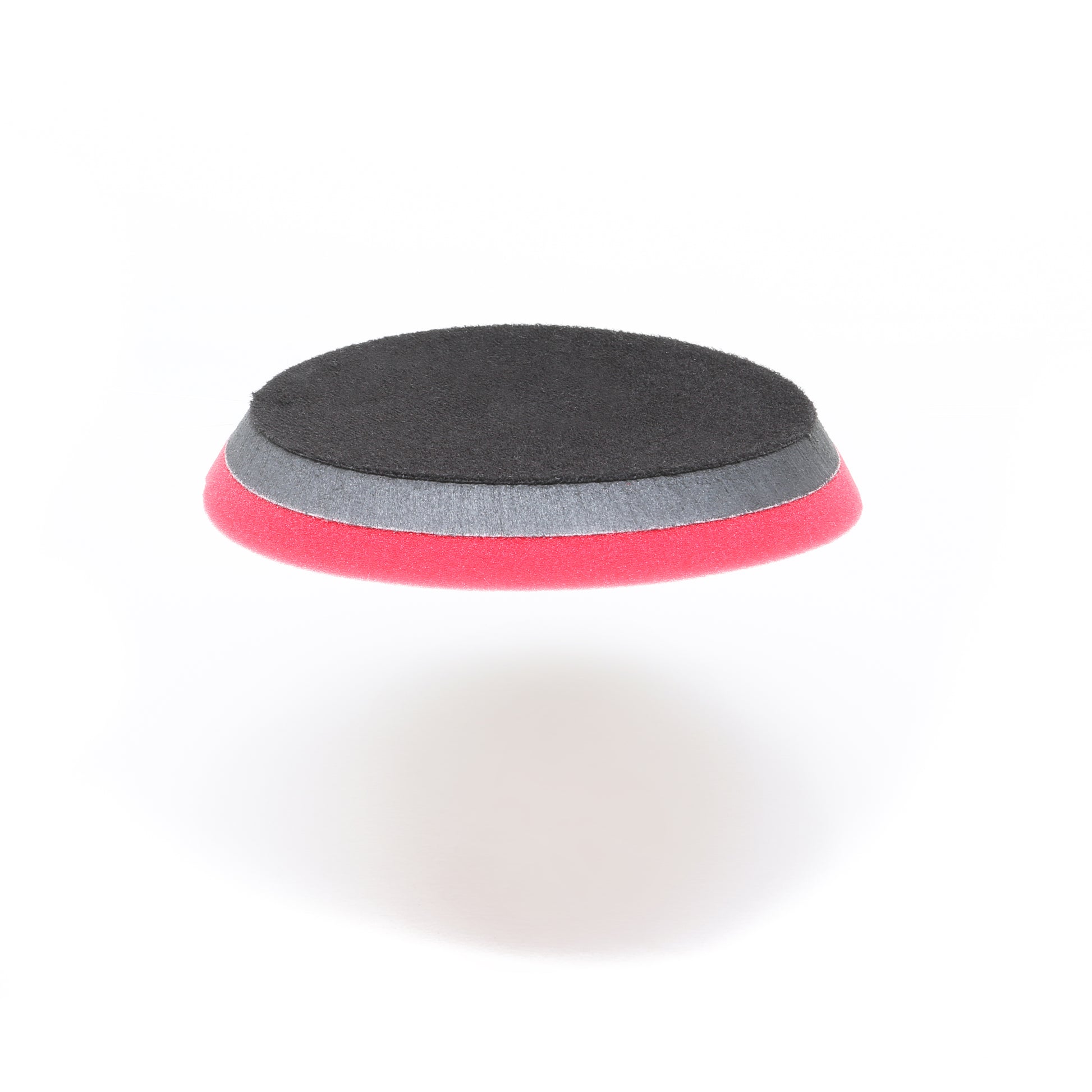 The Shurhold Industries Pro Polish Pad for DAP PRO, a circular 7 three-layer foam pad in black, gray, and pink, is shown on a white background. Ideal for polishing and waxing with the Shurhold Dual Action Polisher PRO.