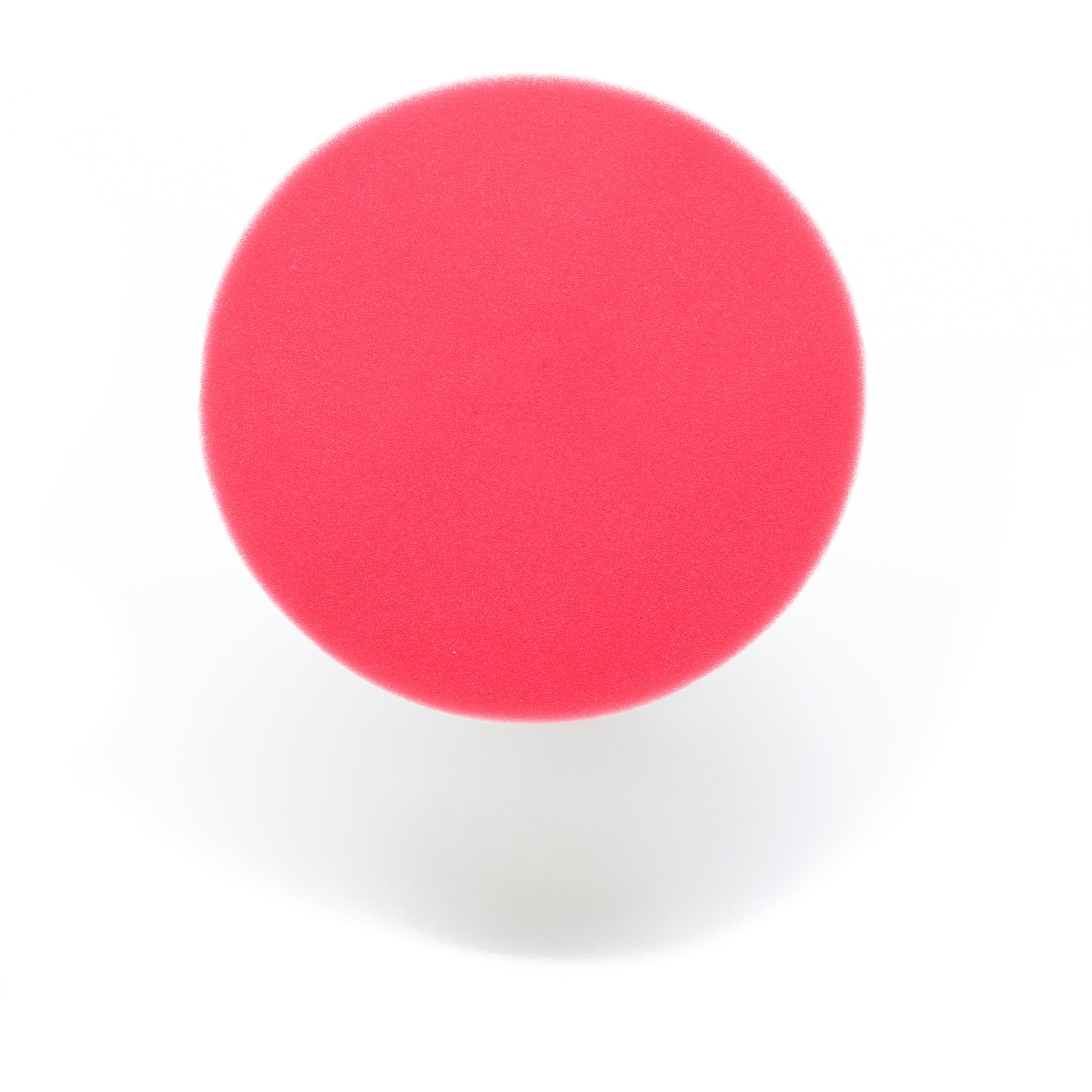 A Pro Polish Pad for DAP PRO by Shurhold Industries, Inc. is photographed from above against a white background, its round red form casting a faint shadow below.