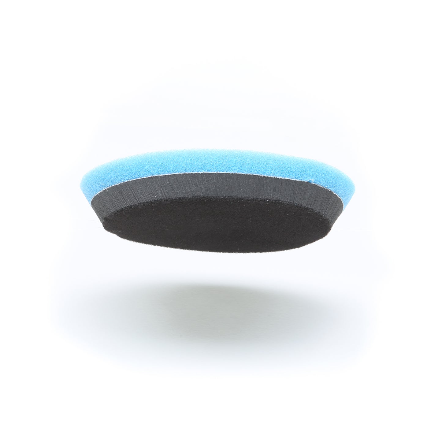 The Shurhold Industries Buff Magic Heavy Oxidation Pad features a round foam design with a blue top and black bottom, shown on a white background—perfect for removing severe oxidation when used with your Dual Action Polisher PRO.