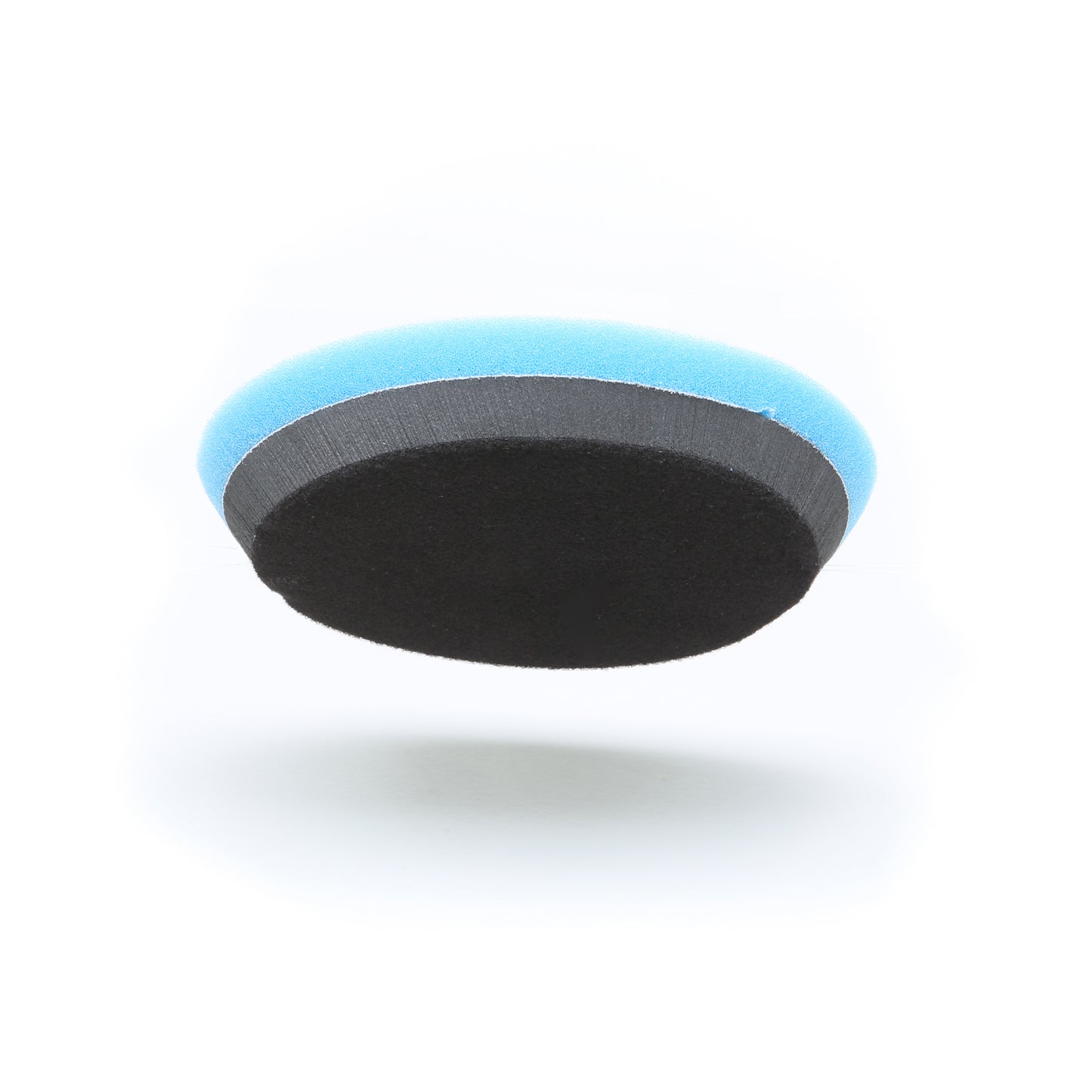 The Shurhold Industries, Inc. Buff Magic Heavy Oxidation Pad is a round, two-tone pad with a blue top and black bottom—perfect for removing severe oxidation when used with the Dual Action Polisher PRO. Photographed on a white background.