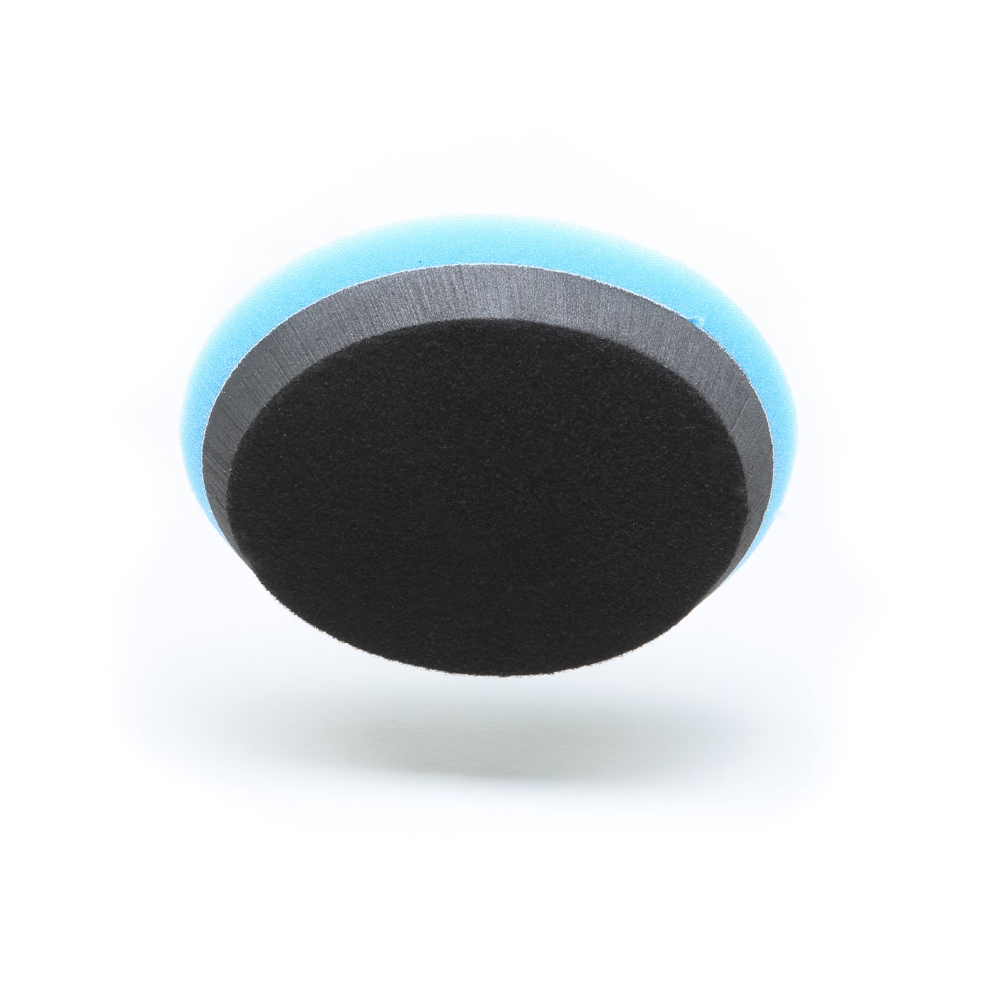 A Shurhold Industries Buff Magic Heavy Oxidation Pad, made of blue and black foam, is shown from above on a white background. Designed for use with the Dual Action Polisher PRO, its ideal for severe oxidation removal.