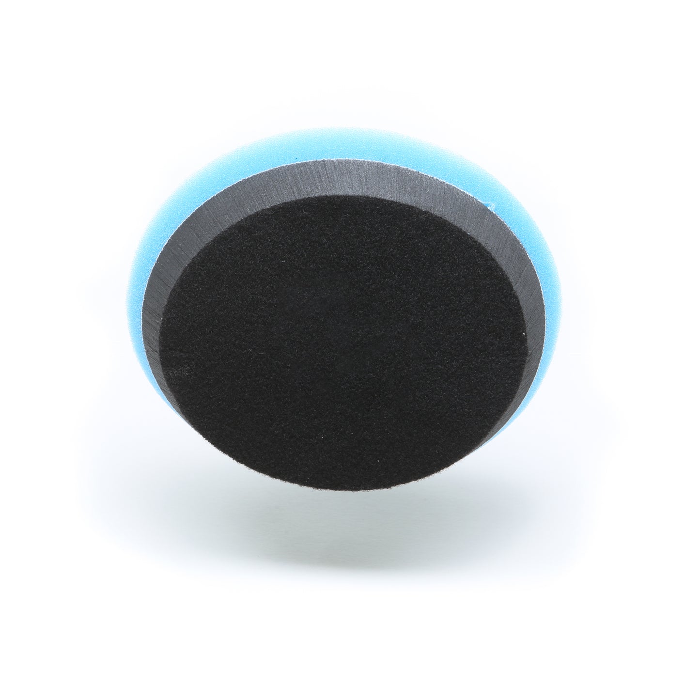 A Shurhold Industries, Inc. Buff Magic Heavy Oxidation Pad—a round foam pad with a black surface and blue edge, designed for the Dual Action Polisher PRO—shown on a white background; ideal for heavy oxidation removal.