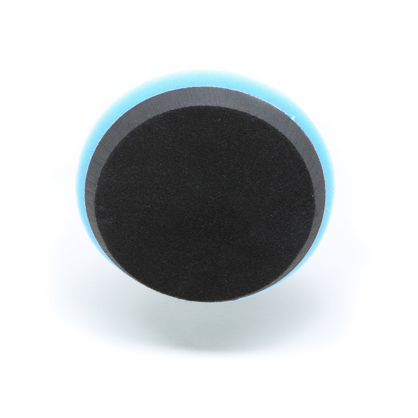 A round, black and blue Buff Magic Heavy Oxidation Pad by Shurhold Industries, Inc., seen from above with a black center and blue edge on a white background, designed for severe oxidation removal with the Dual Action Polisher PRO.