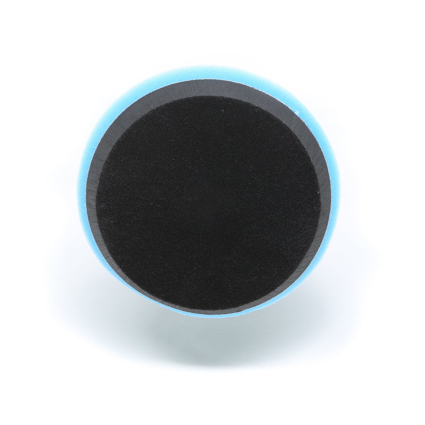 A round black Buff Magic Heavy Oxidation Pad by Shurhold Industries, Inc., with a blue outer edge is shown from above on a white background—ideal for removing severe oxidation with the Shurhold Dual Action Polisher PRO.