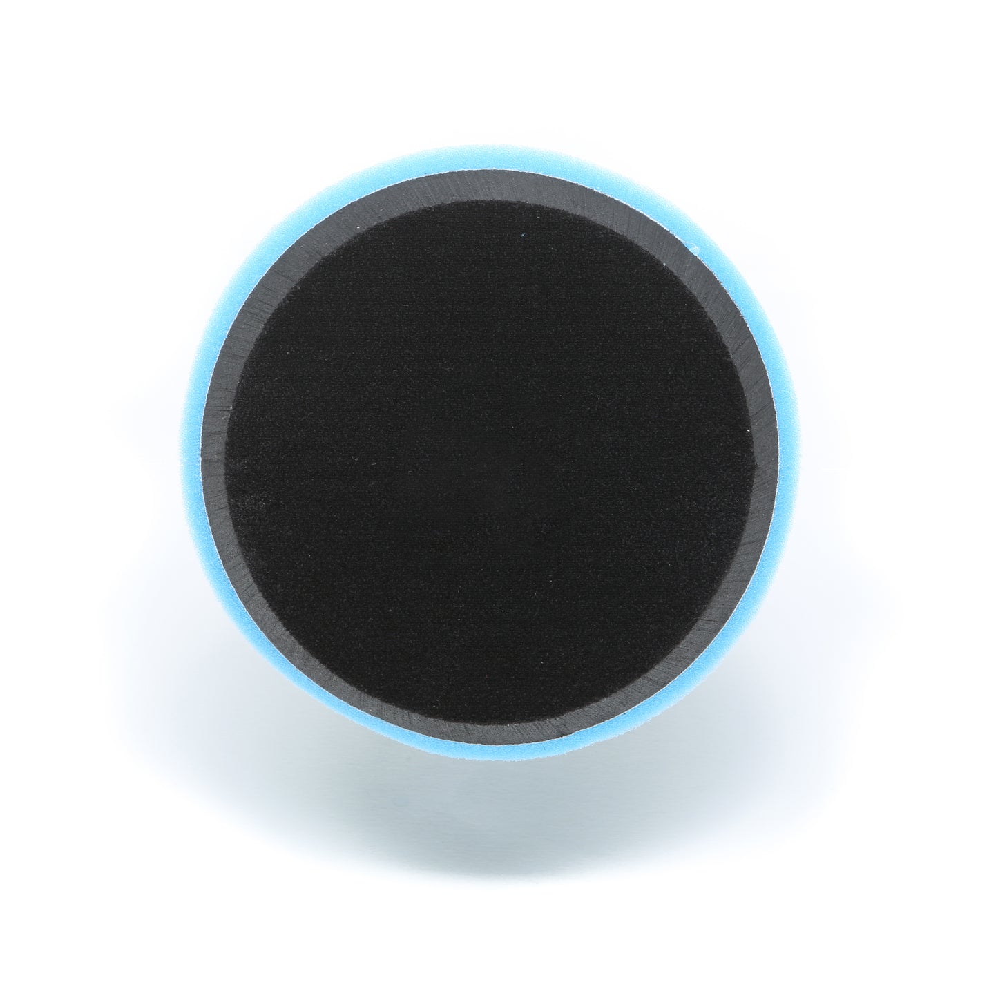 A round black Buff Magic Heavy Oxidation Pad by Shurhold Industries, Inc., with a blue edge, is shown from above on a white background—made for heavy oxidation removal using the Shurhold Dual Action Polisher PRO.