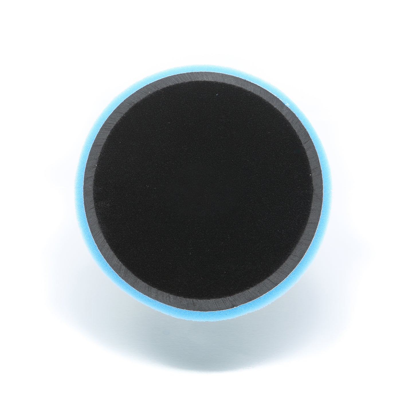 A round black Buff Magic Heavy Oxidation Pad with a blue edge, viewed from above on a white background—designed by Shurhold Industries, Inc. for use with the Dual Action Polisher PRO to remove severe oxidation.