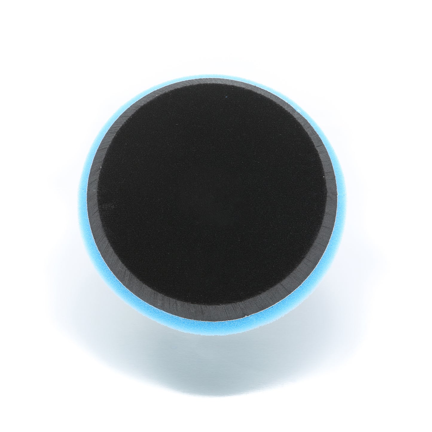 A round Shurhold Industries, Inc. Dual Action Polisher PRO pad with a black foam and blue edge, shown from above on white—perfect for use with the Buff Magic Heavy Oxidation Pad to remove severe oxidation.