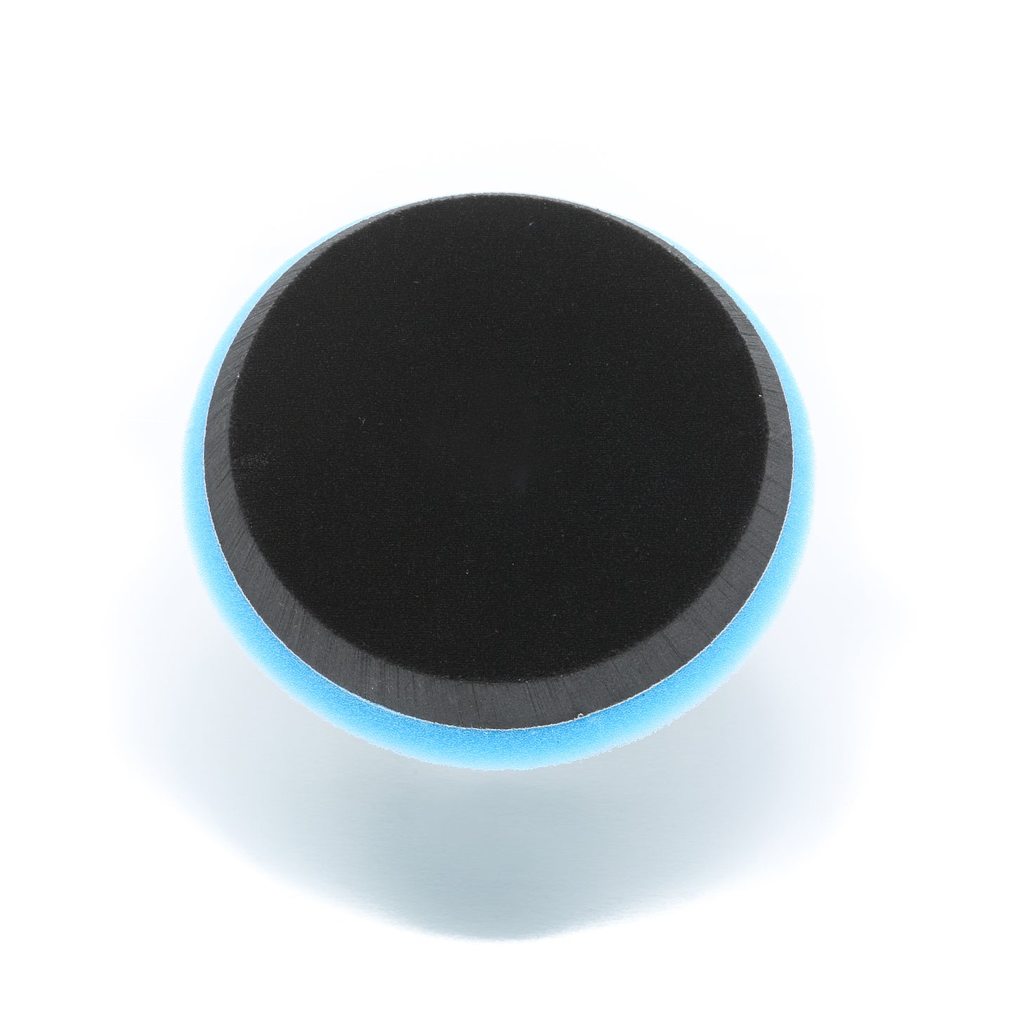 A round black Buff Magic Heavy Oxidation Pad by Shurhold Industries, Inc., with a blue edge, shown from above on white—perfect for tackling severe oxidation using your Shurhold Dual Action Polisher PRO.