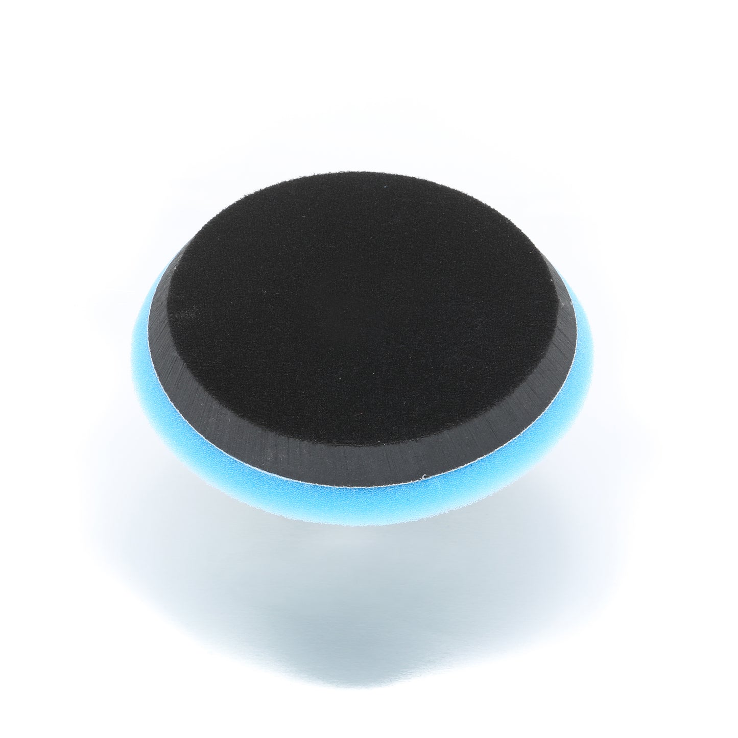 The Buff Magic Heavy Oxidation Pad by Shurhold Industries, Inc. is a round, two-toned foam pad for the Dual Action Polisher PRO, designed to tackle severe oxidation. Features a black top, blue sides, and shown on a white background.