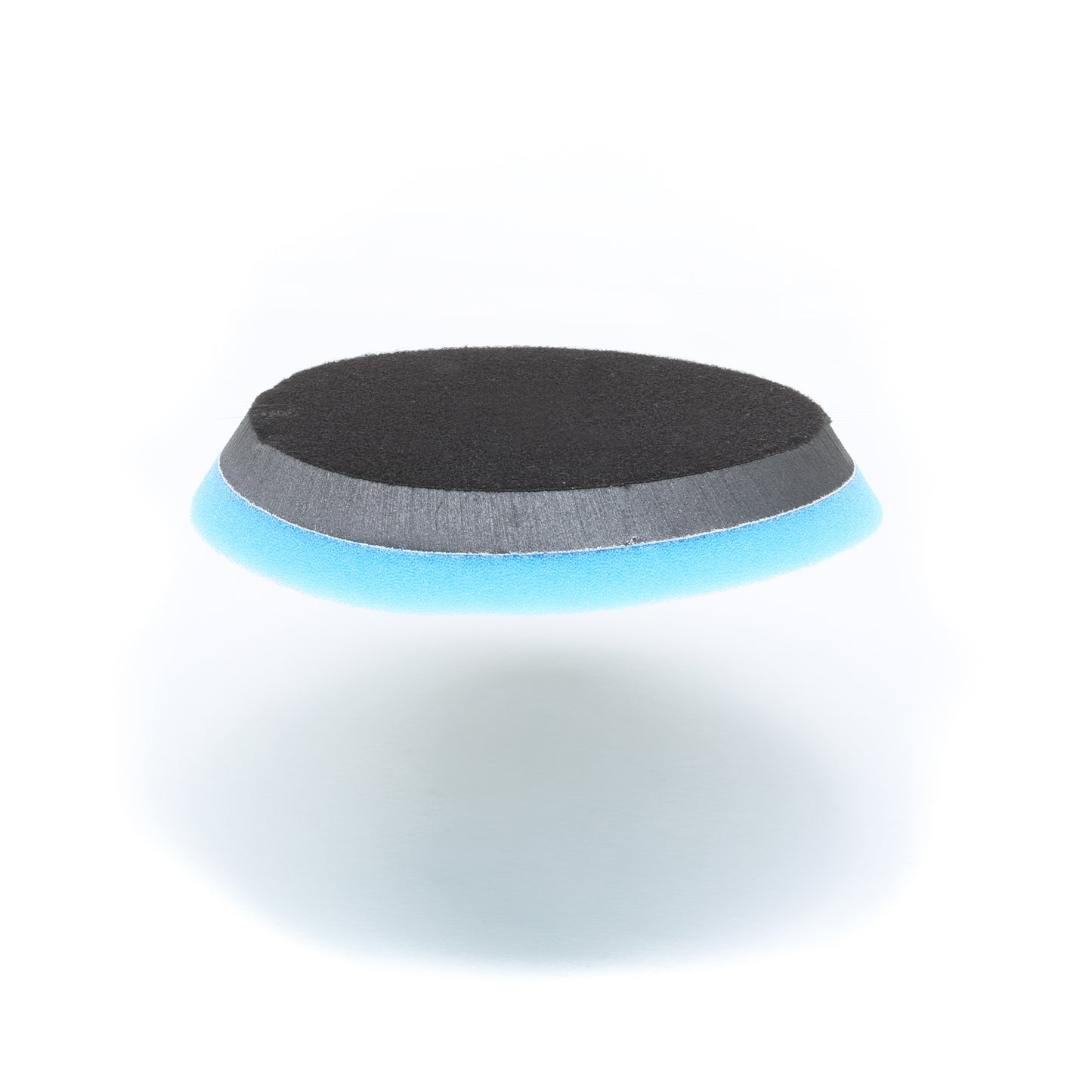 The Shurhold Industries, Inc. Buff Magic Heavy Oxidation Pad is a round pad with black, gray, and blue layers, designed for the Dual Action Polisher PRO to tackle severe oxidation. Shown on a white background.