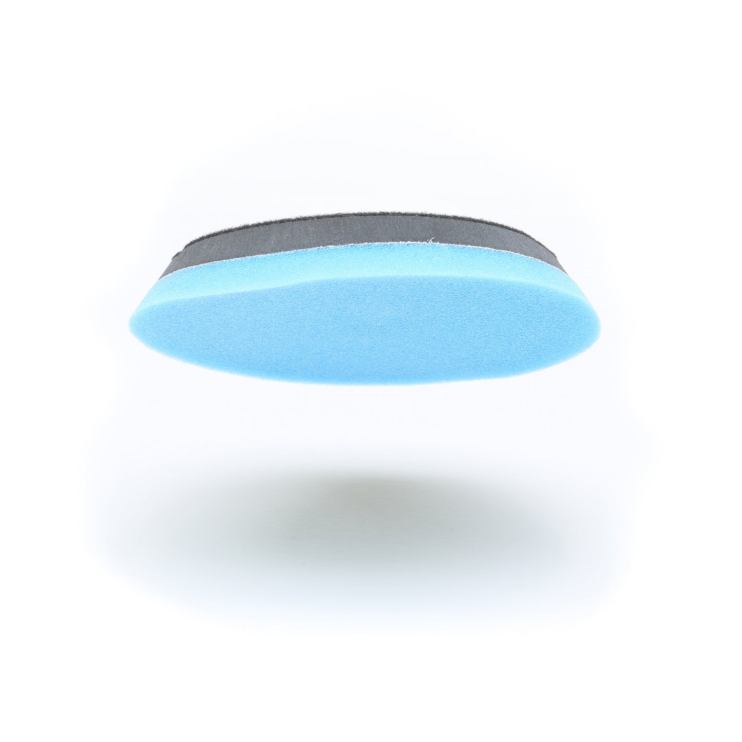 A close-up of Shurhold Industries, Inc.s Buff Magic Heavy Oxidation Pad, an oval, two-tone foam sponge with a blue bottom and black top—designed for severe oxidation—shown on a white background.