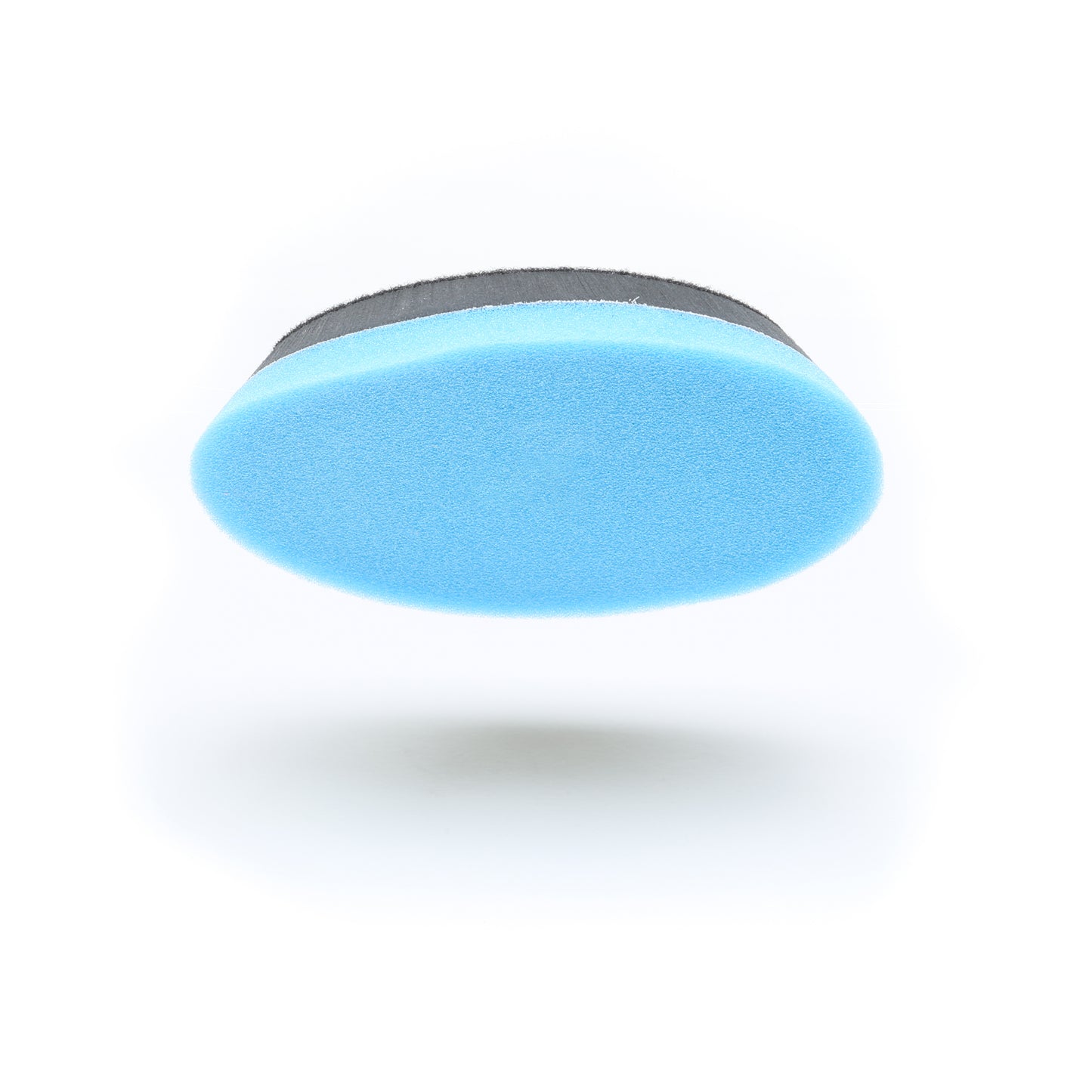 A blue, oval-shaped Buff Magic Heavy Oxidation Pad by Shurhold Industries, Inc. with a black edge is displayed on a white background and photographed from below.