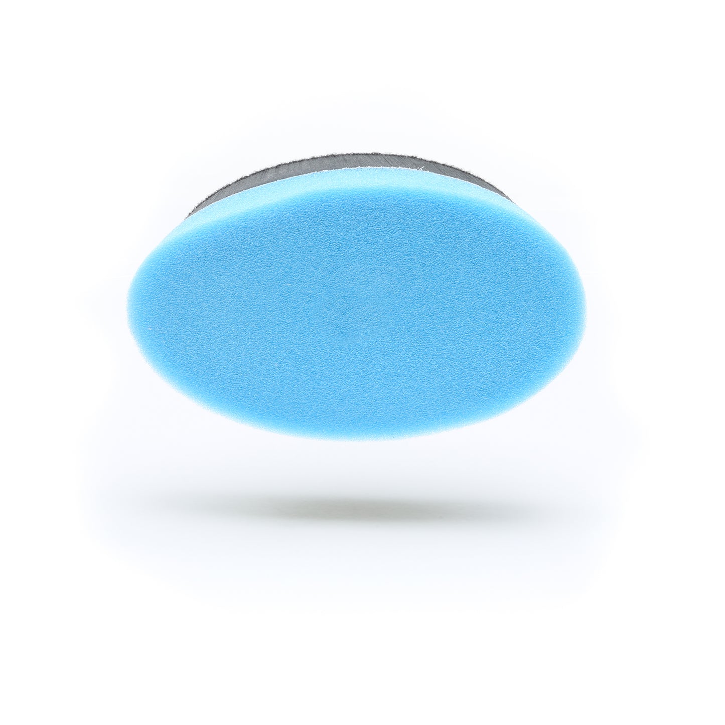 Blue oval Buff Magic Heavy Oxidation Pad by Shurhold Industries, Inc. with a black edge shown against a white background, casting a soft shadow—ideal for tackling severe oxidation with the Shurhold Dual Action Polisher PRO.