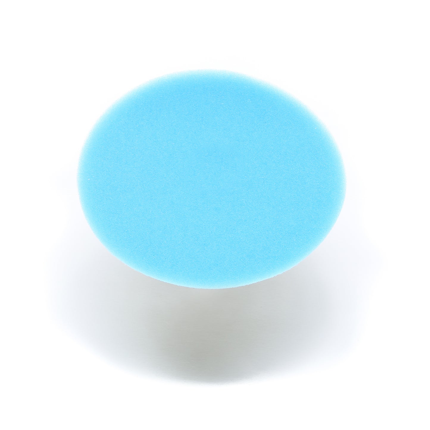 A round, blue Buff Magic Heavy Oxidation Pad by Shurhold Industries, Inc. is photographed from above on a white background with a faint shadow beneath—ideal for removing severe oxidation using the Shurhold Dual Action Polisher PRO.