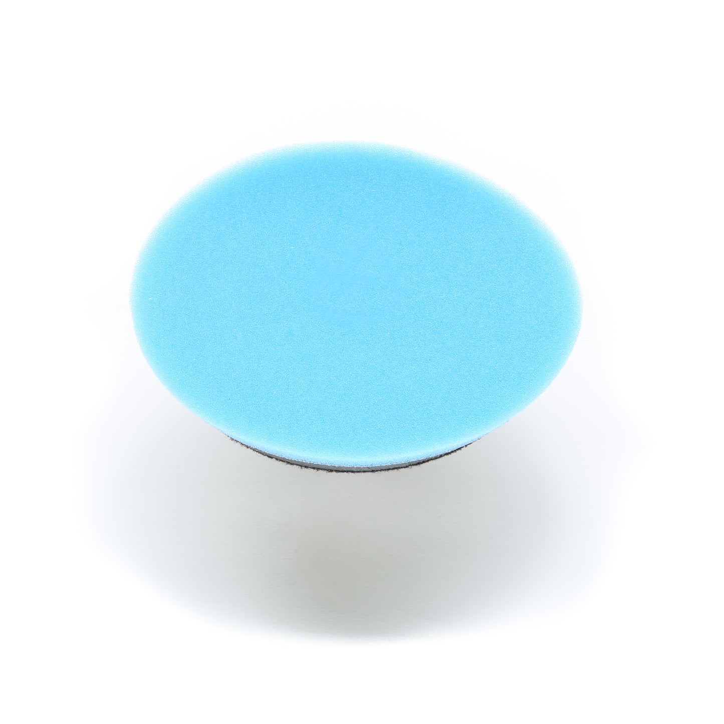 A blue circular Buff Magic Heavy Oxidation Pad by Shurhold Industries, Inc. is photographed from above on a white background—ideal for severe oxidation when used with the Shurhold Dual Action Polisher PRO.