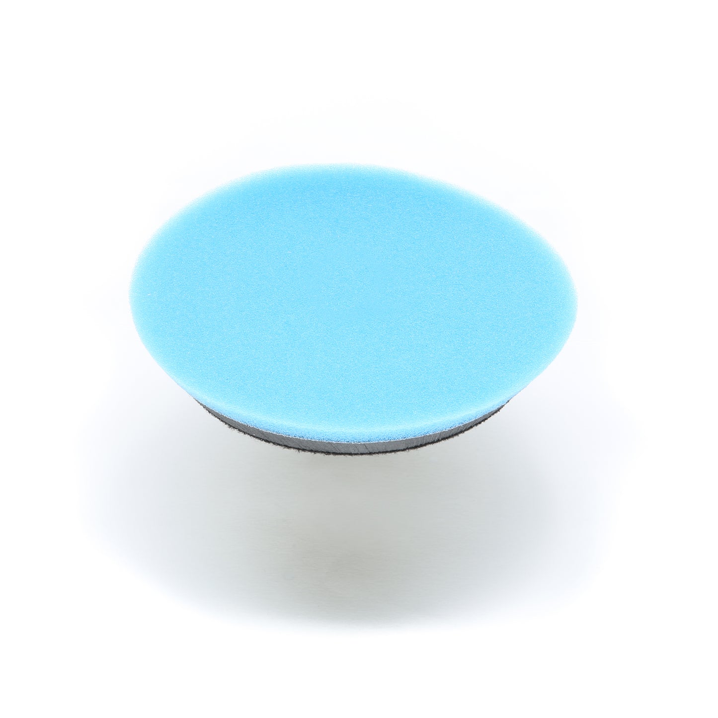 A round blue sponge with a black base, the Shurhold Industries, Inc. Buff Magic Heavy Oxidation Pad is shown against a white background—ideal for tackling severe oxidation when used with the Dual Action Polisher PRO.
