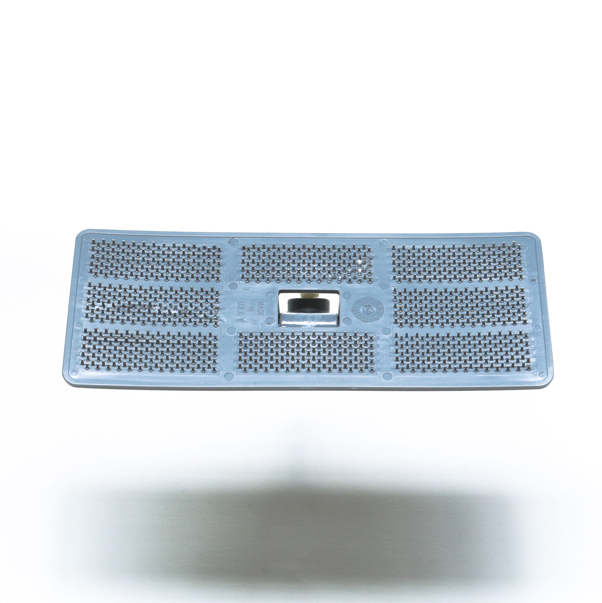 Rectangular gray Swivel Pad Base by Shurhold Industries, Inc., featuring multiple small raised holes and a central metal blade, compatible with Shurhold attachments, photographed against a white background.