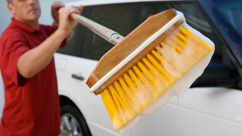 Man with a soapy Shurhold Brush