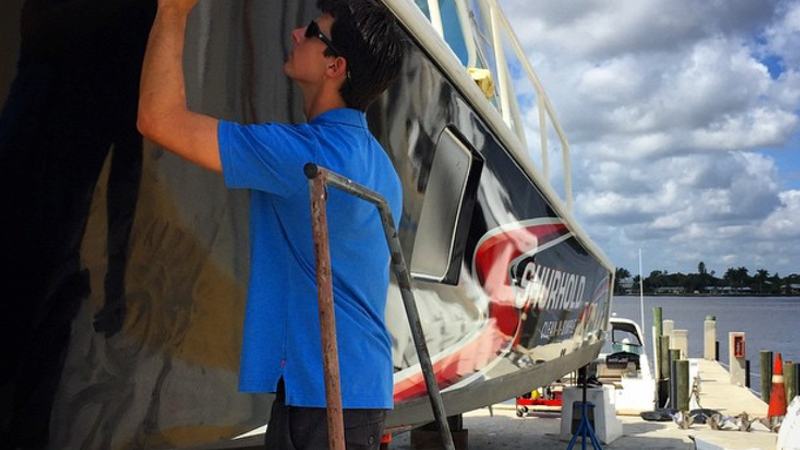 Man waxing a boat