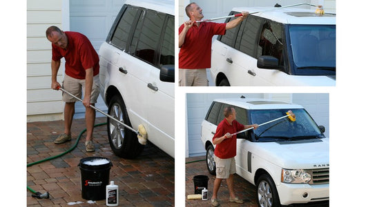 A man cleans a SUV with the Shurhold System. 