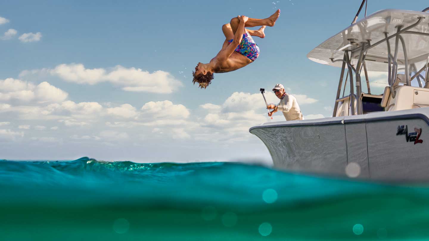 kid doing backflip off boat