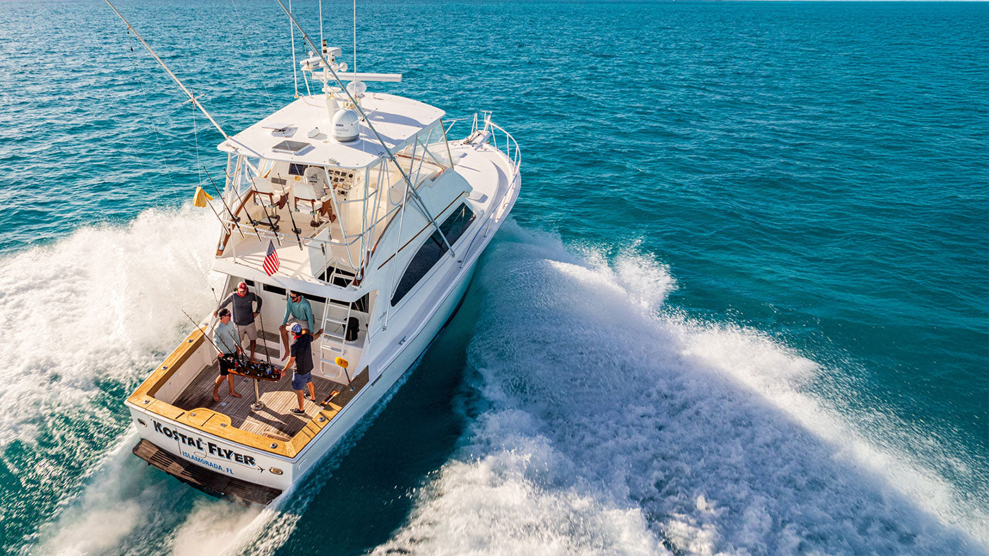 boat on ocean with four guys in back