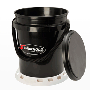 Black plastic Shurhold bucket with a rope handle, white base, and a removable lid placed beside it.