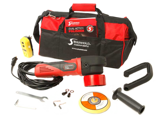 A Shurhold dual action polisher kit with a red and black polisher, power cord, handles, discs, tools, manual, and a black and red carrying bag displayed on a white surface.